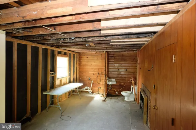 a view of a room with chair and a ceiling fan