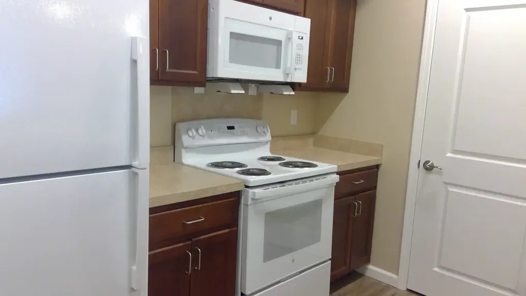 265 West 15th Street Panama City, FL 32401 - Photo 10 of 11 a kitchen with a stove and a microwave