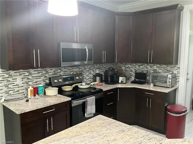 a kitchen with a sink dishwasher a stove and a refrigerator