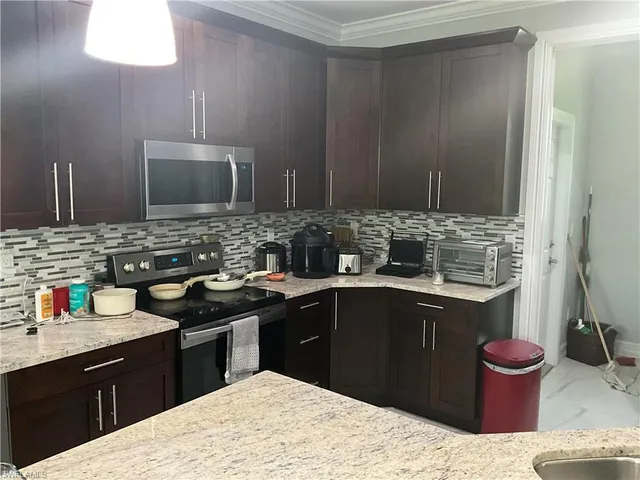 a kitchen with a sink stove and cabinets