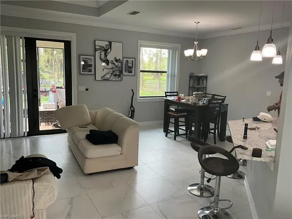 a living room with furniture and a floor to ceiling window