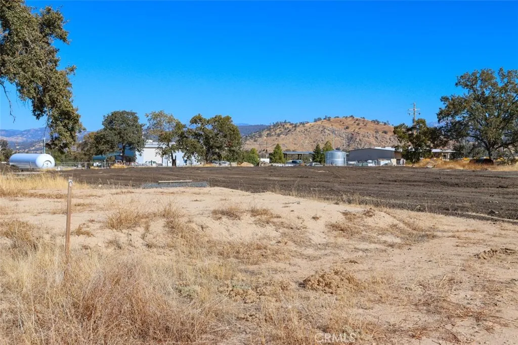 0 Wisteria O'Neals, CA 93645 - Photo 10 of 17 a view of dirt yard with mountain and trees around