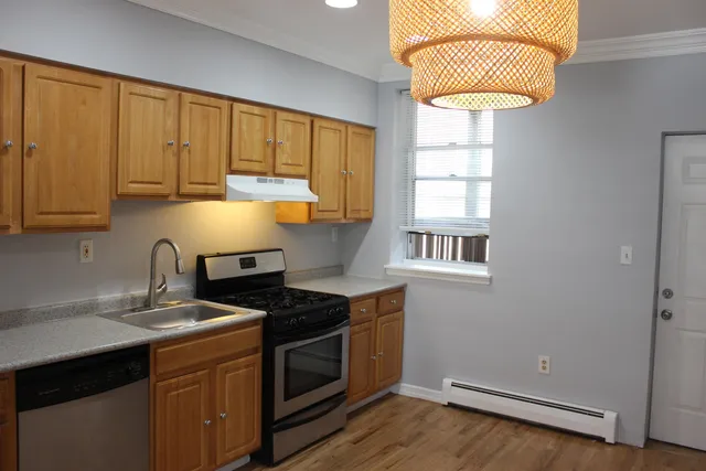 a kitchen with a sink cabinets and window