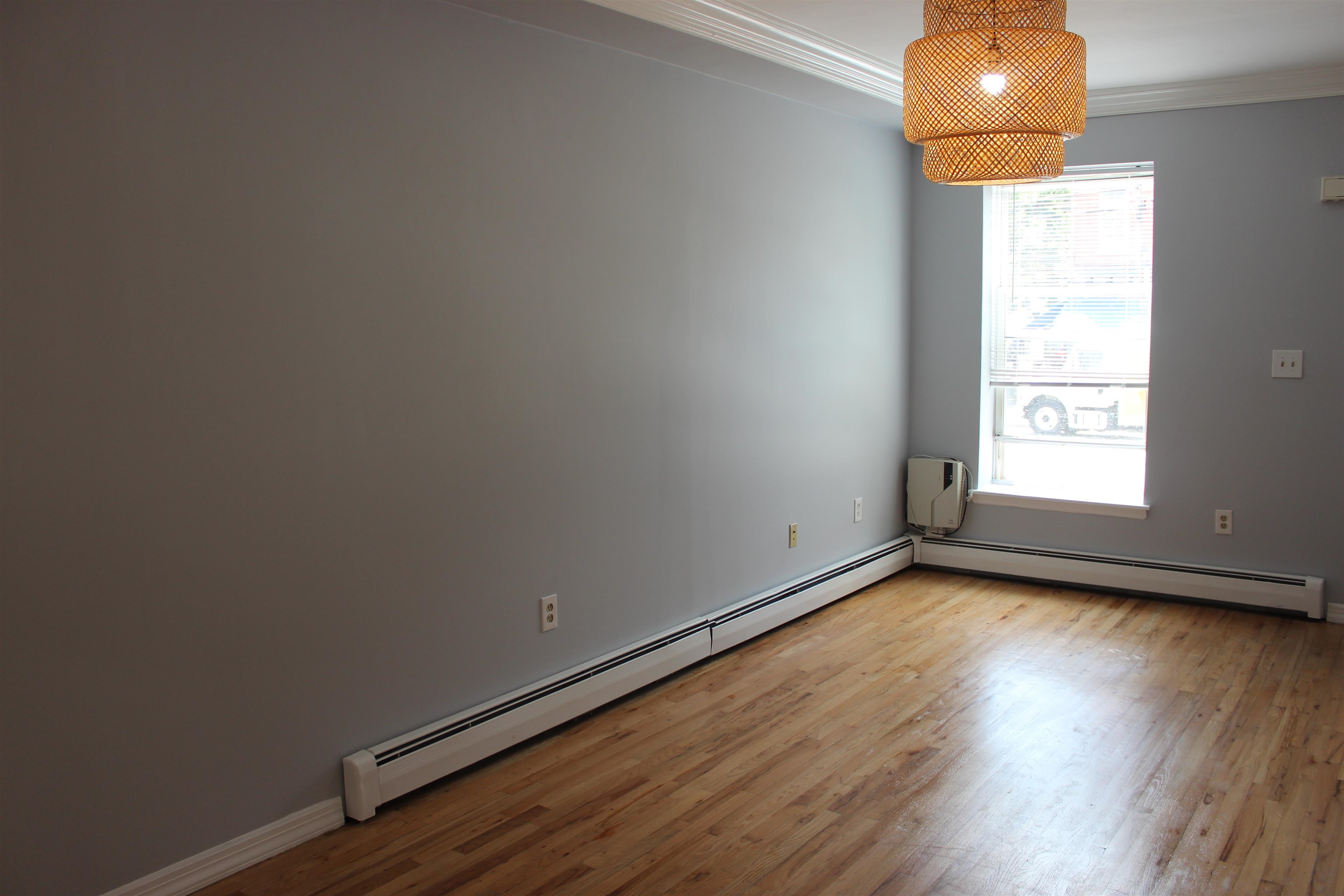 182 Christopher Columbus Drive, Unit 2 Jersey City, NJ 07302 - Photo 11 of 12 a view of a room with wooden floor and a window