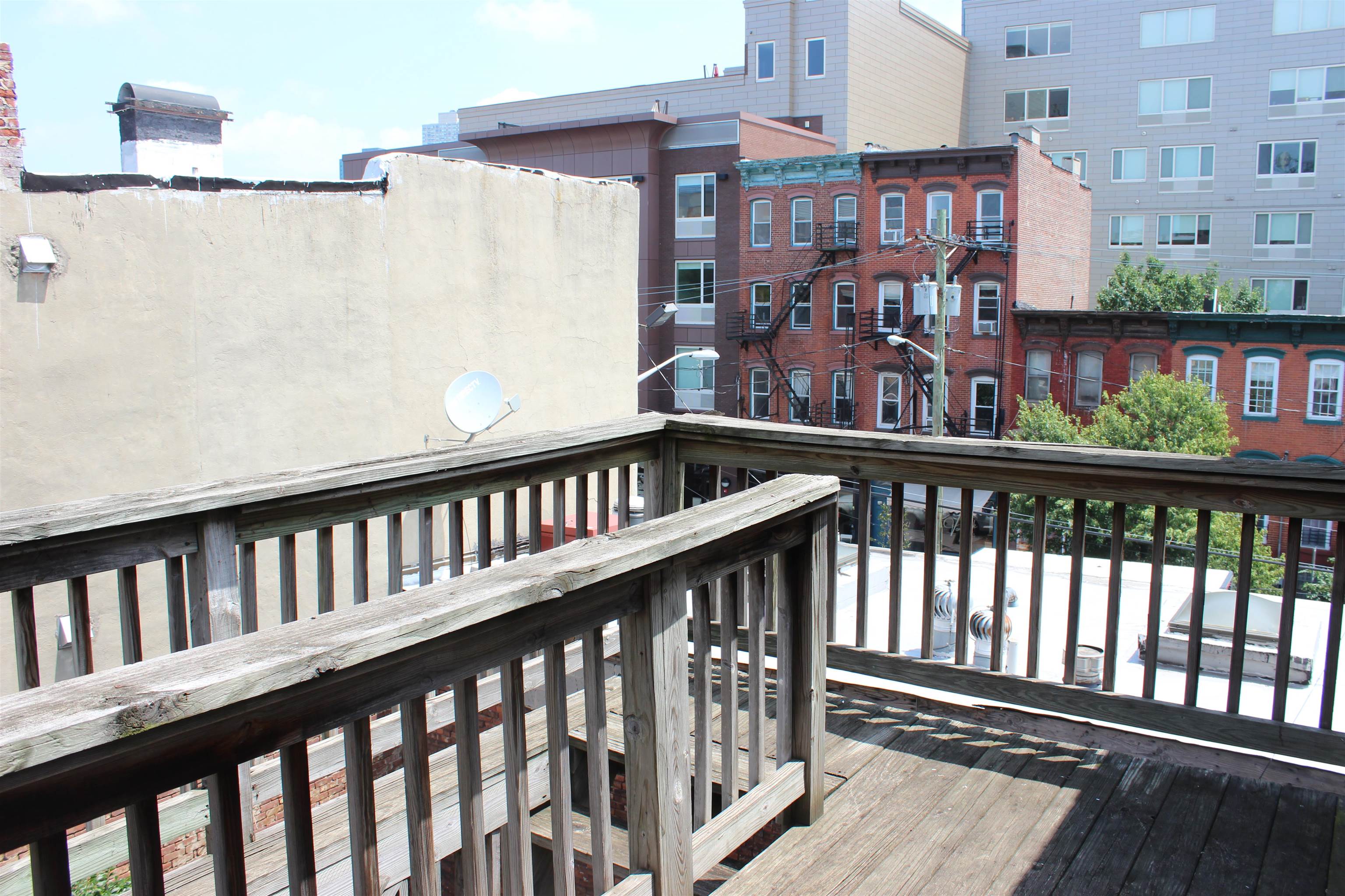 182 Christopher Columbus Drive, Unit 2 Jersey City, NJ 07302 - Photo 6 of 12 a view of a brick building from a balcony