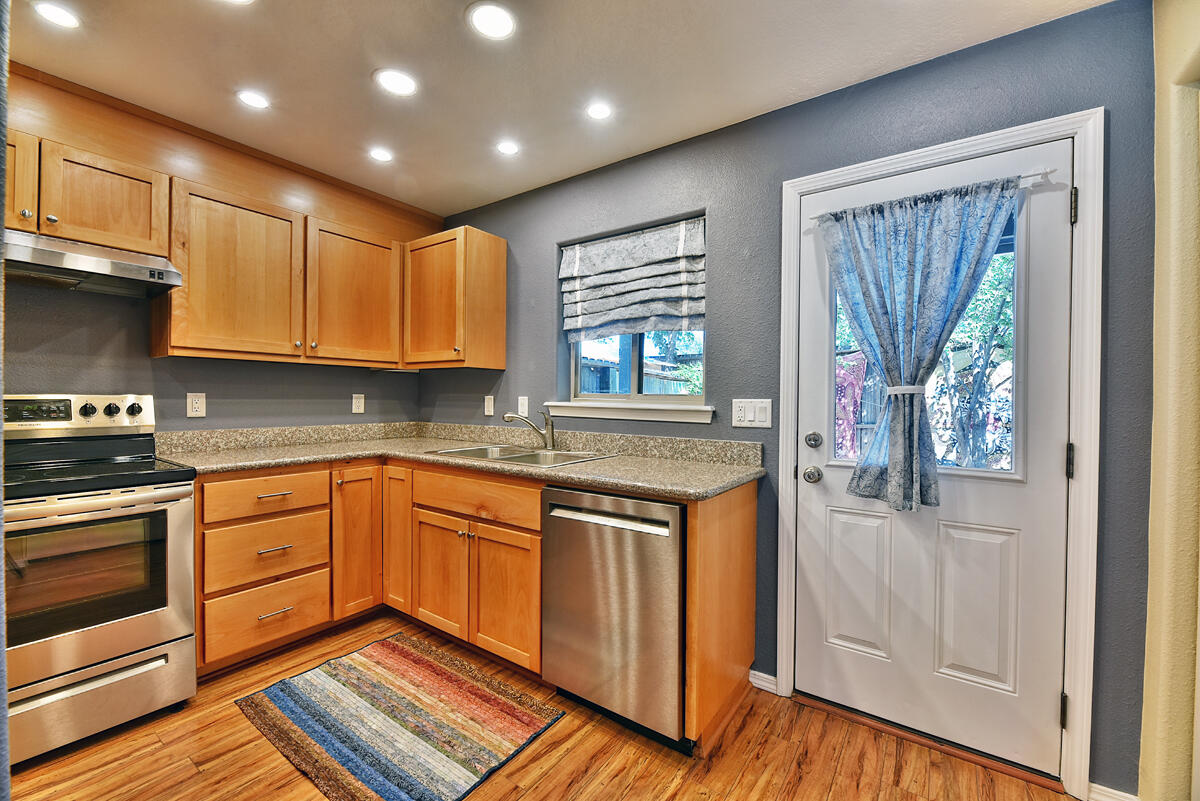 450 Midway Road, Unit 39 Medford, OR 97501 - Photo 5 of 21 a kitchen with granite countertop wooden cabinets stainless steel appliances and a window