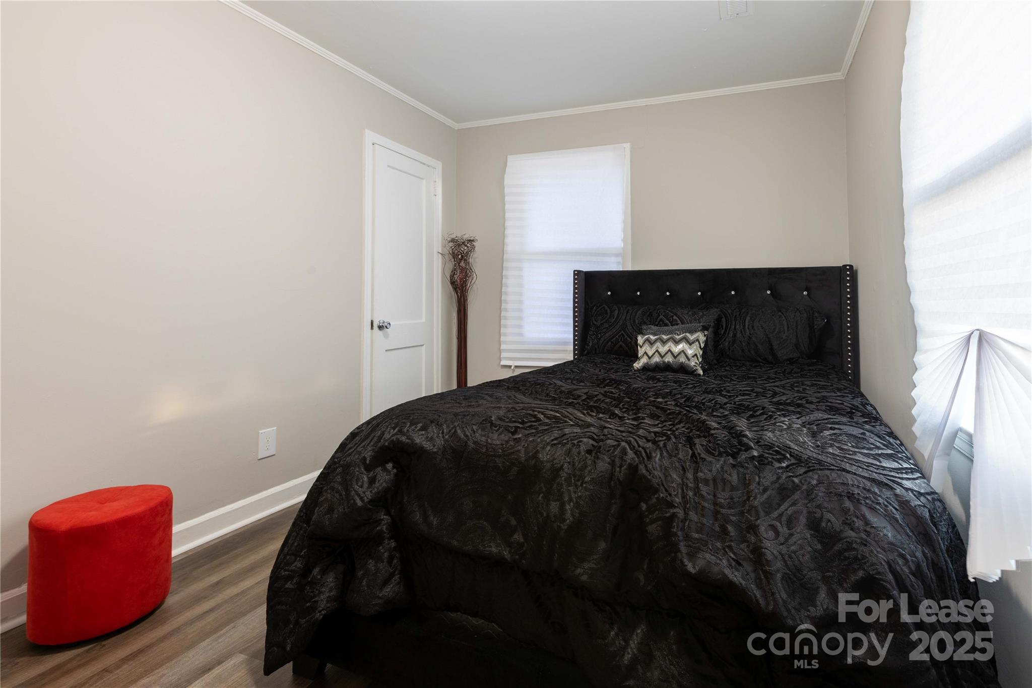 2012 Double Oaks Road Charlotte, NC 28206 - Photo 11 of 14 a bedroom with a bed and a dresser