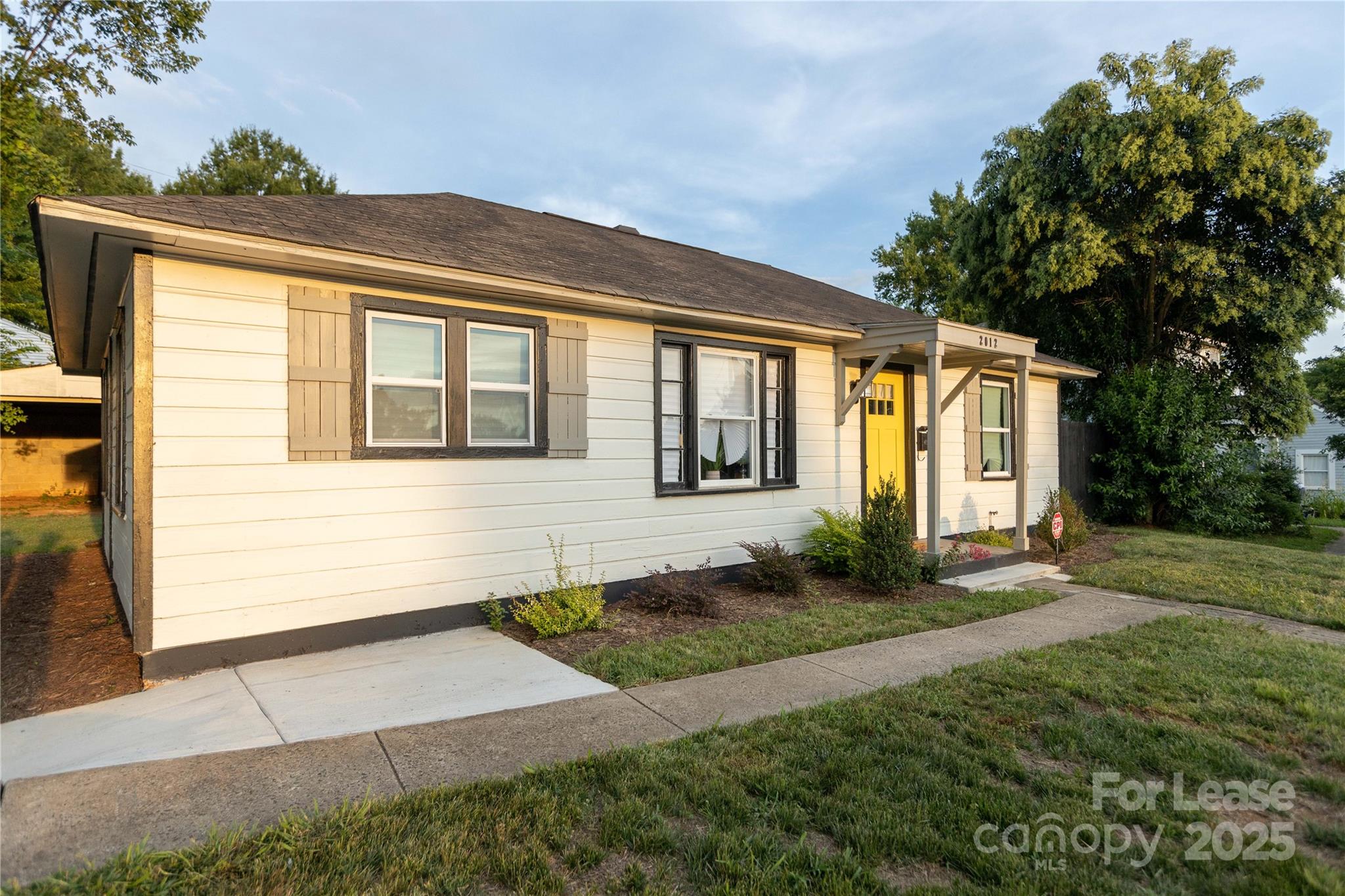 2012 Double Oaks Road Charlotte, NC 28206 - Photo 2 of 14 a front view of a house with a yard and trees