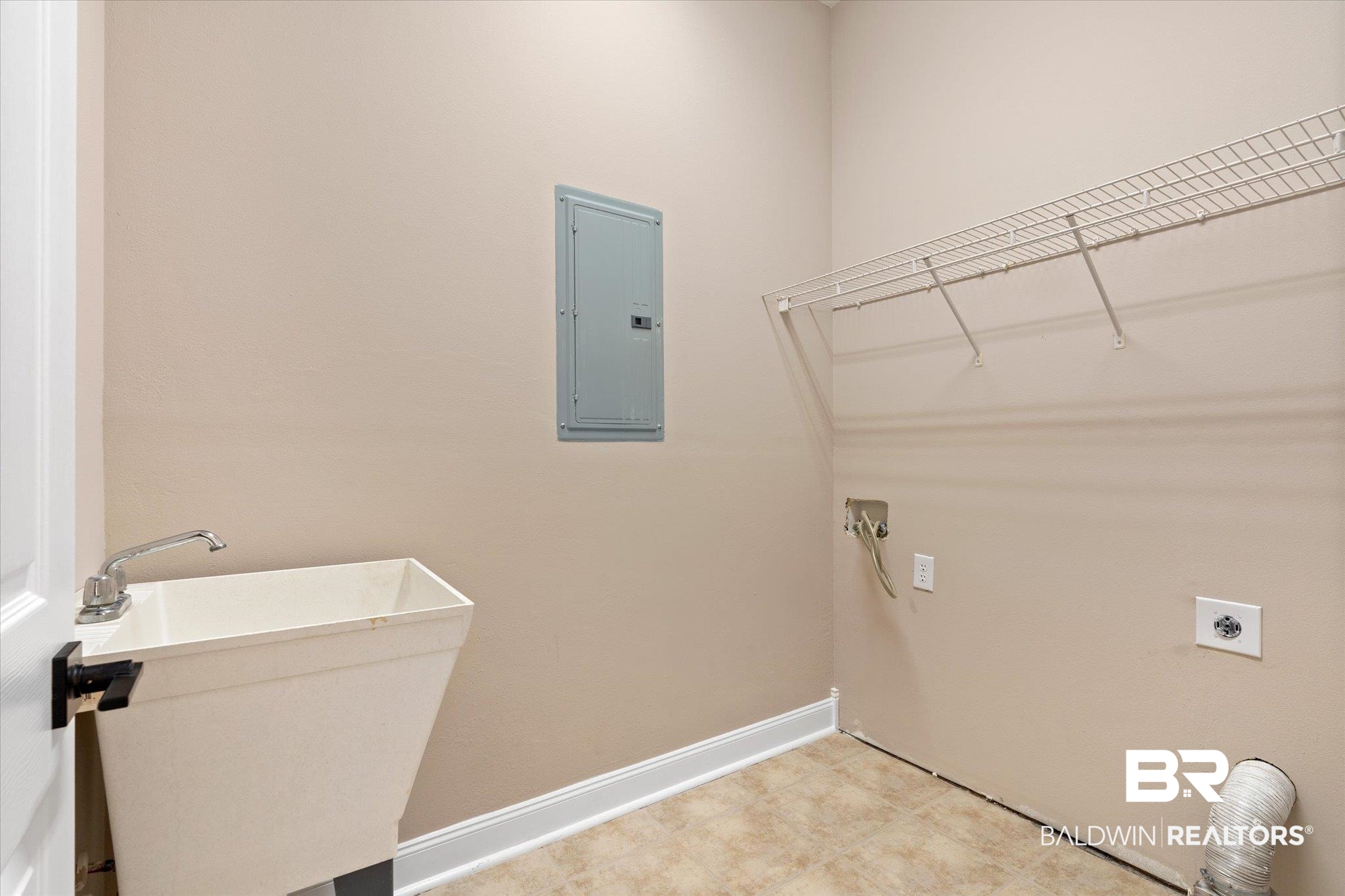 9259 Genipa Way Gulf Shores, AL 36542 - Photo 36 of 72 Laundry room featuring electric panel, hookup for an electric dryer, and sink