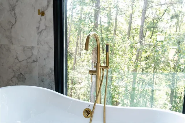 a bathroom with a tub and shower