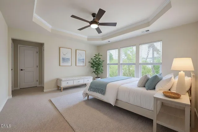 a bedroom with a bed a couch and a large window