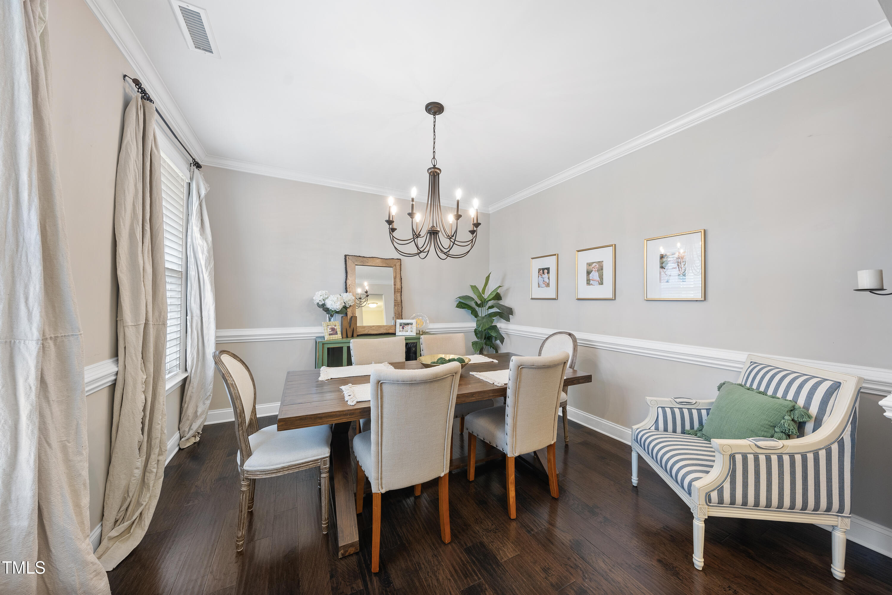 714 Chapanoke Road Raleigh, NC 27603 - Photo 3 of 45 a dining room with furniture a chandelier and wooden floor