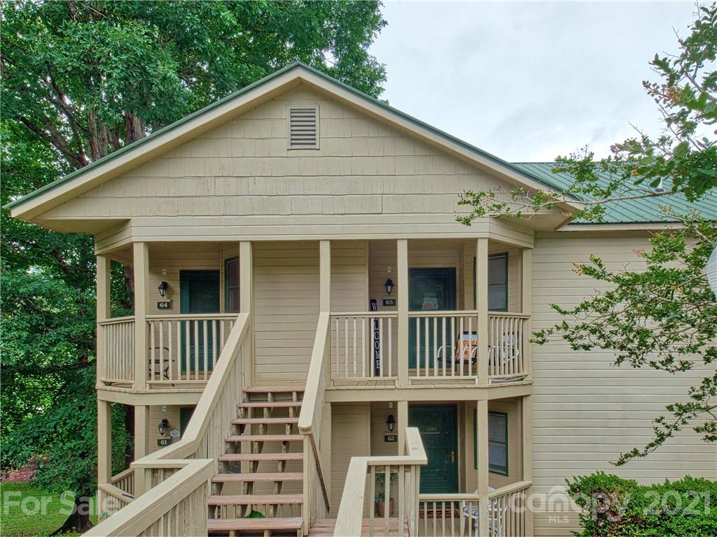 160 Whitney Boulevard, Unit 65 Lake Lure, NC 28746 - Photo 2 of 21 a front view of a house with a yard