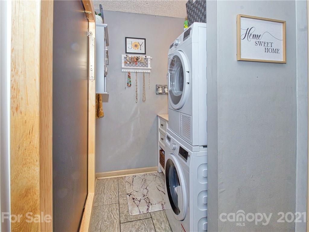 160 Whitney Boulevard, Unit 65 Lake Lure, NC 28746 - Photo 12 of 21 a utility room with dryer and washer