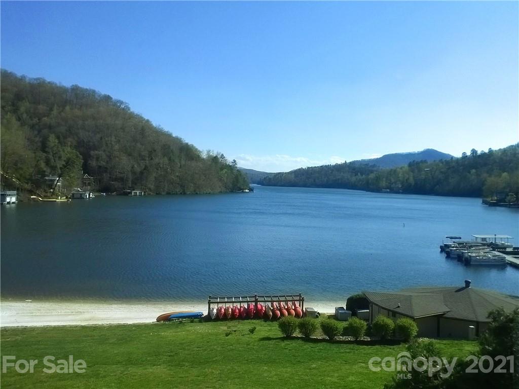 160 Whitney Boulevard, Unit 65 Lake Lure, NC 28746 - Photo 16 of 21 a view of a lake with houses in the back