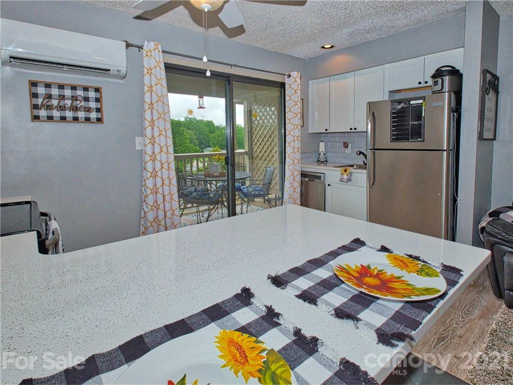 160 Whitney Boulevard, Unit 65 Lake Lure, NC 28746 - Photo 6 of 21 a room with furniture and a floor to ceiling window