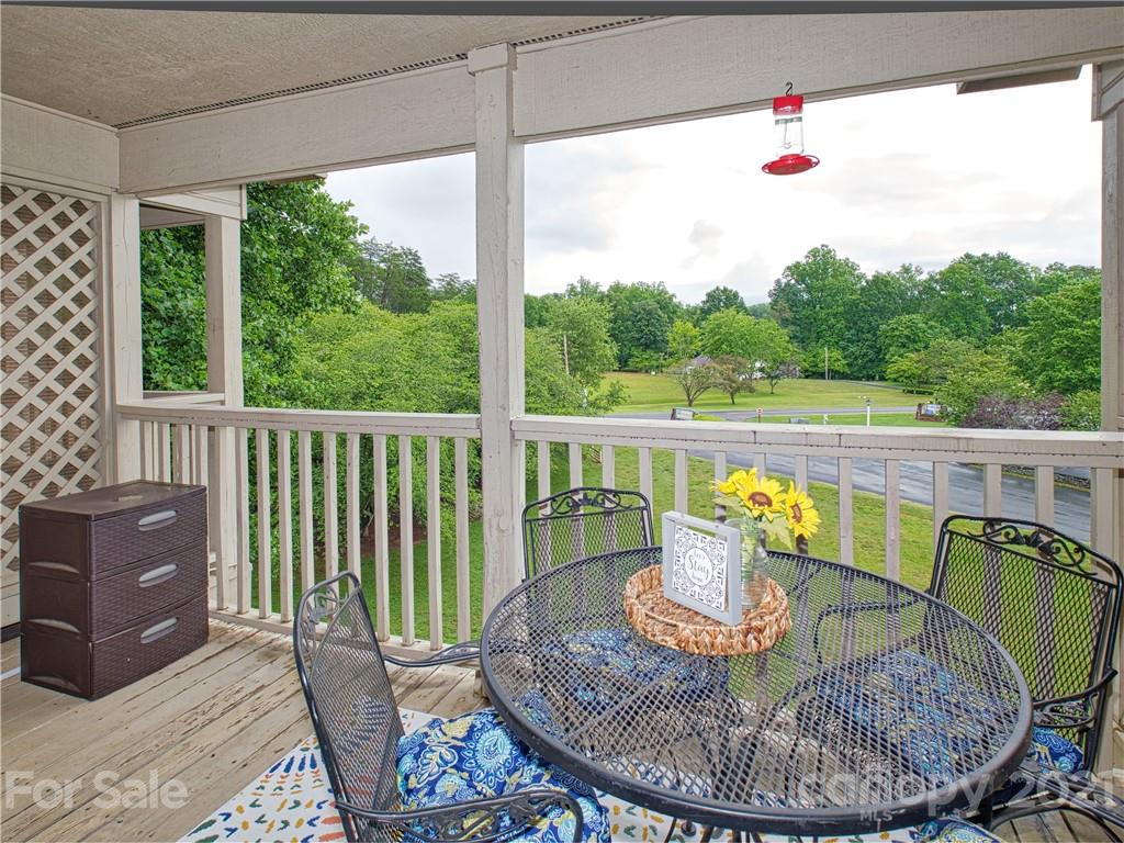 160 Whitney Boulevard, Unit 65 Lake Lure, NC 28746 - Photo 10 of 21 a view of a dining room with furniture window and outside view