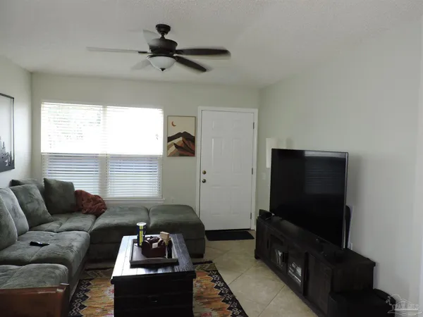 a living room with furniture and a flat screen tv