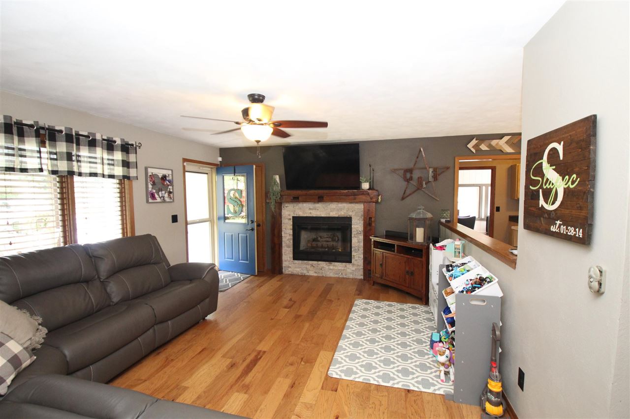 3684 Valerie Road Roscoe, IL 61073 - Photo 2 of 26 a living room with furniture and a fireplace