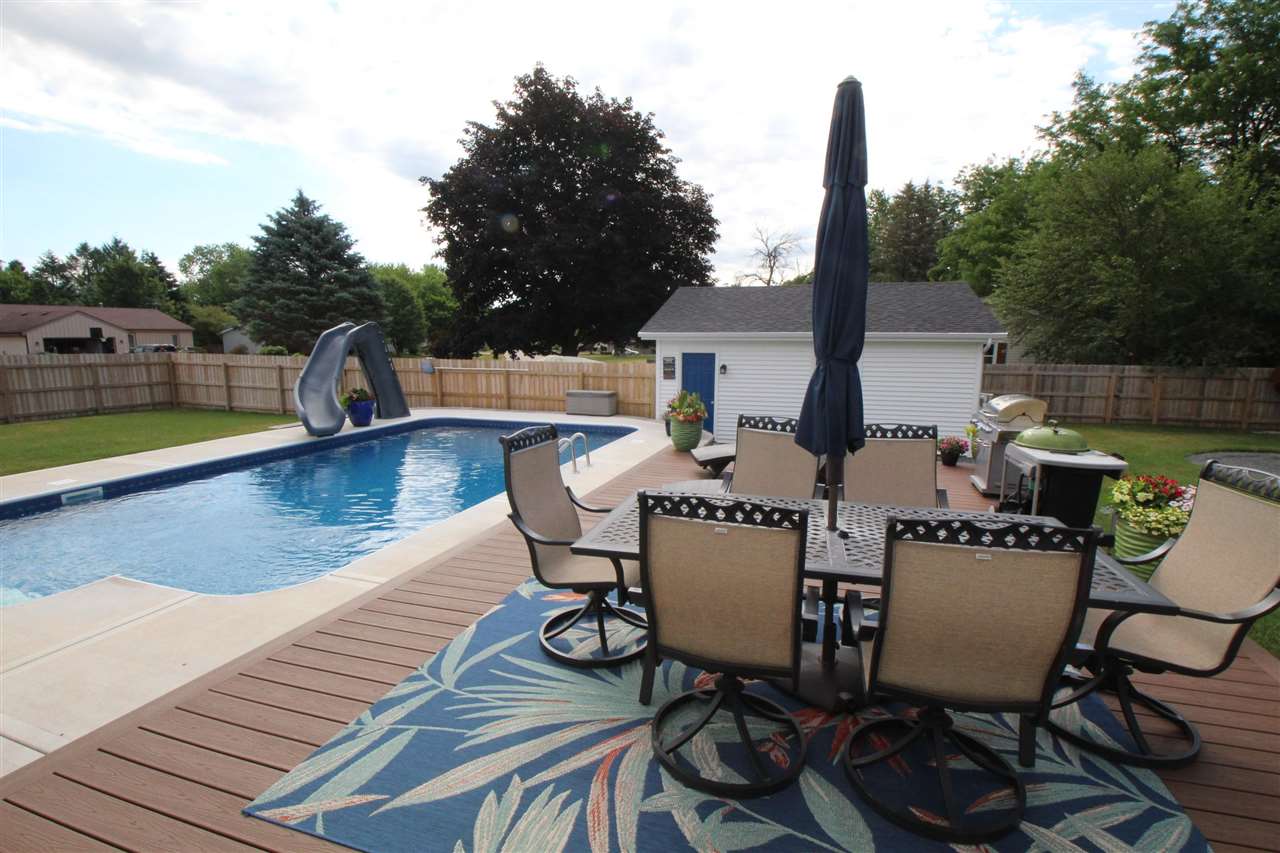 3684 Valerie Road Roscoe, IL 61073 - Photo 23 of 26 a view of a patio with table and chairs with wooden floor and fence