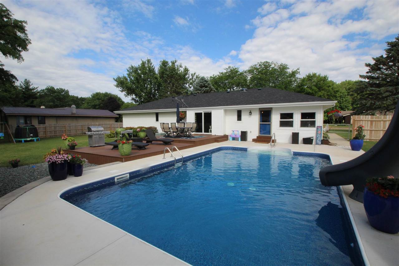 3684 Valerie Road Roscoe, IL 61073 - Photo 24 of 26 a view of a house with pool fire pit a patio and a garden