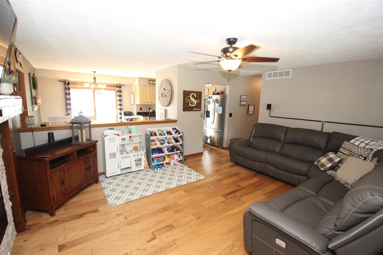 3684 Valerie Road Roscoe, IL 61073 - Photo 3 of 26 a living room with furniture and chandelier
