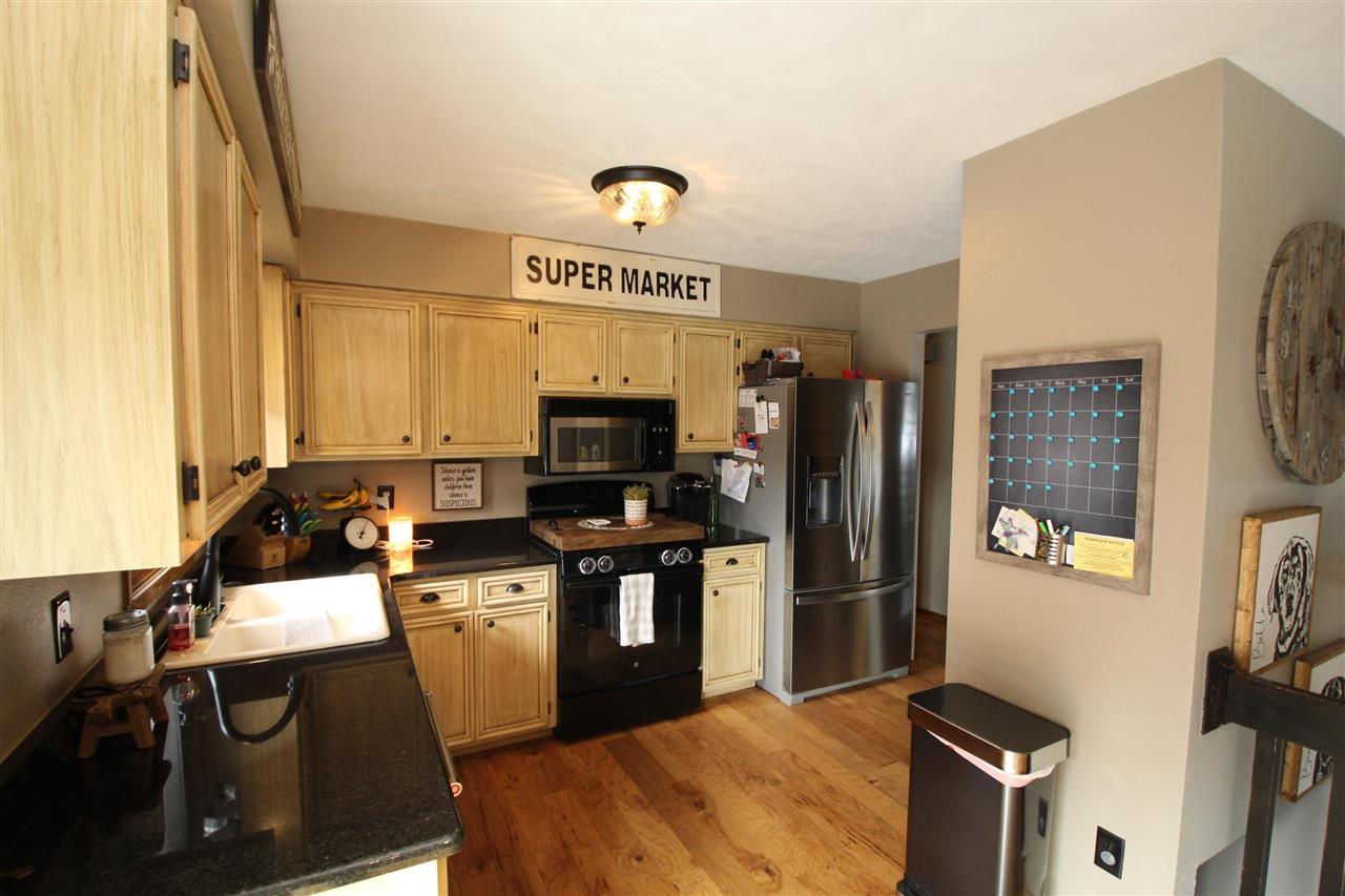 3684 Valerie Road Roscoe, IL 61073 - Photo 5 of 26 a kitchen with a sink stainless steel appliances a refrigerator and a stove top oven
