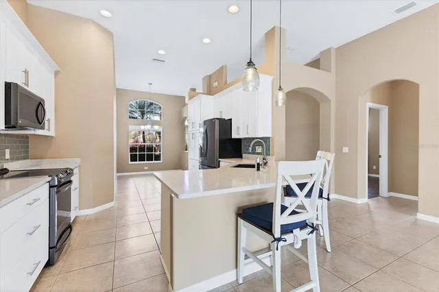 a kitchen with a stove a sink and a refrigerator