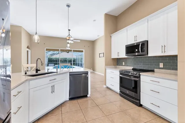 a kitchen with stainless steel appliances a refrigerator sink and cabinets