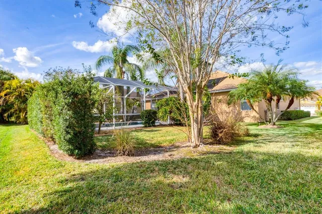 an aerial view of a house with a yard and lake view
