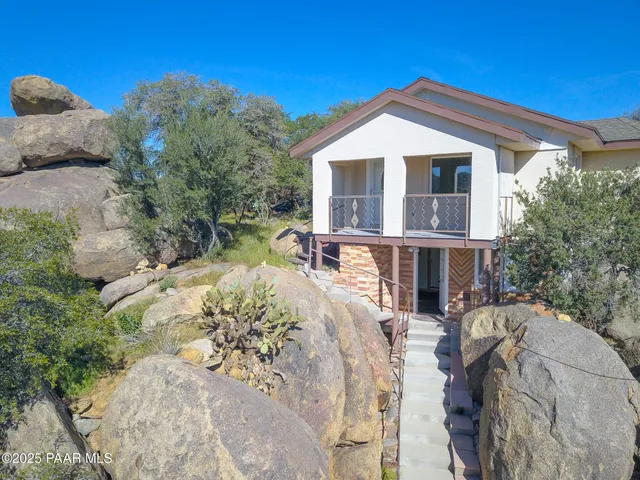 a view of a patio with couches chairs and potted plants