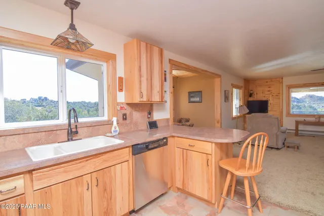 a kitchen with a table chairs sink and cabinets