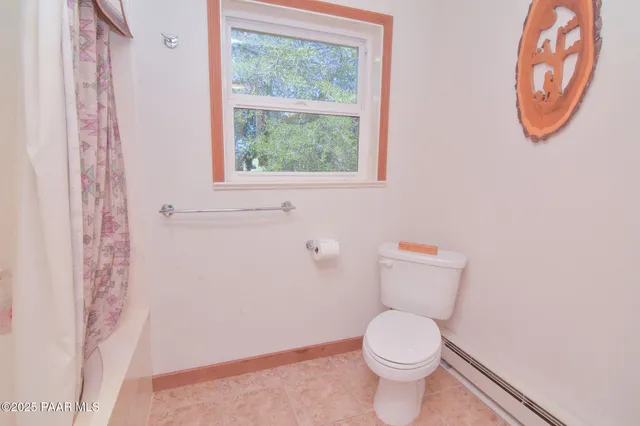 a white toilet sitting next to a window