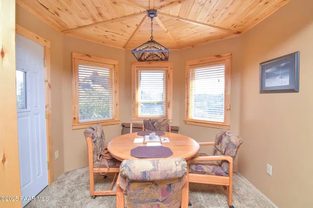 a dining room with furniture and window
