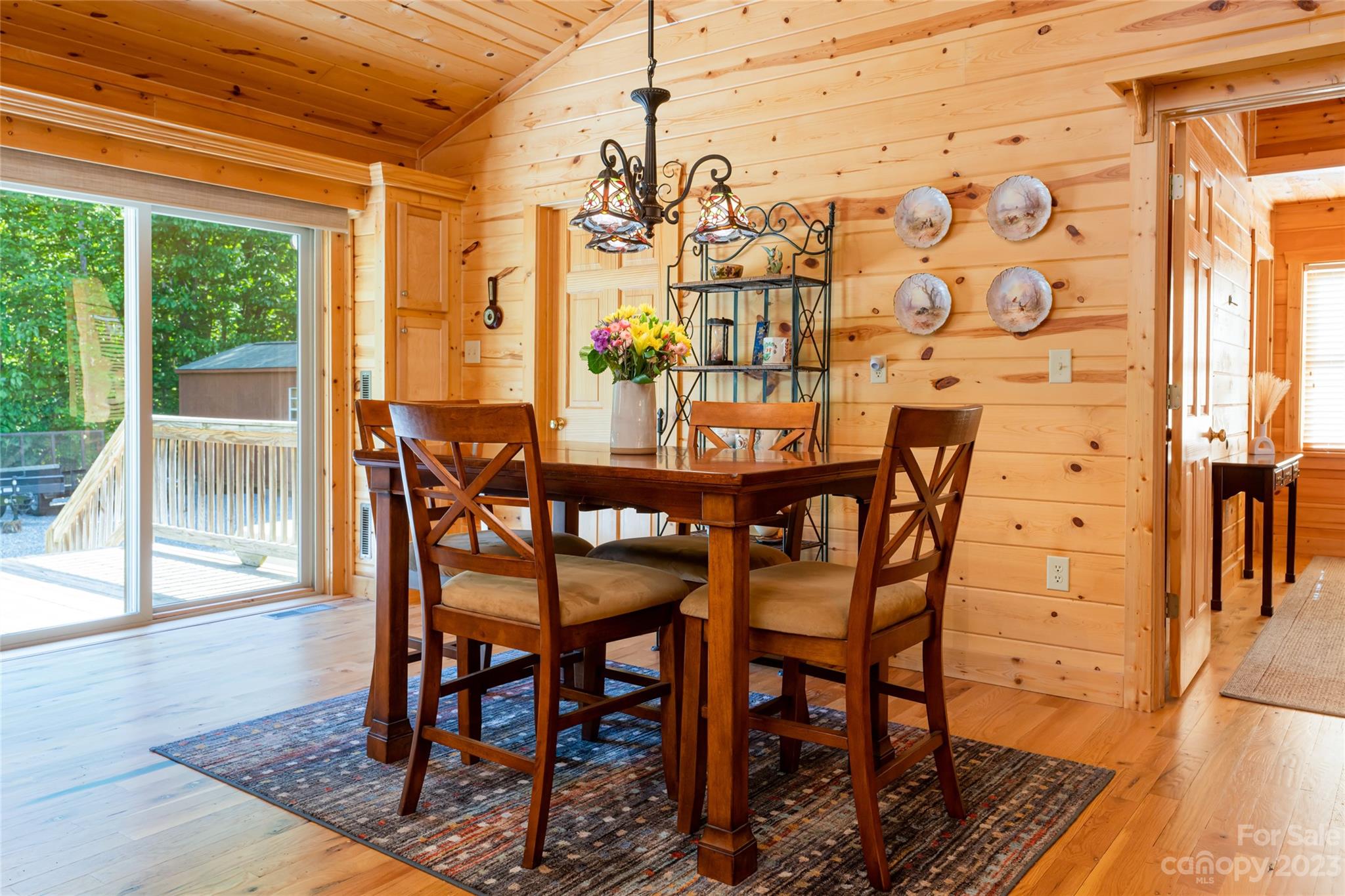 134 Quebec Trail Bostic, NC 28018 - Photo 11 of 37 a view of a dining room with furniture wooden floor and a potted plant