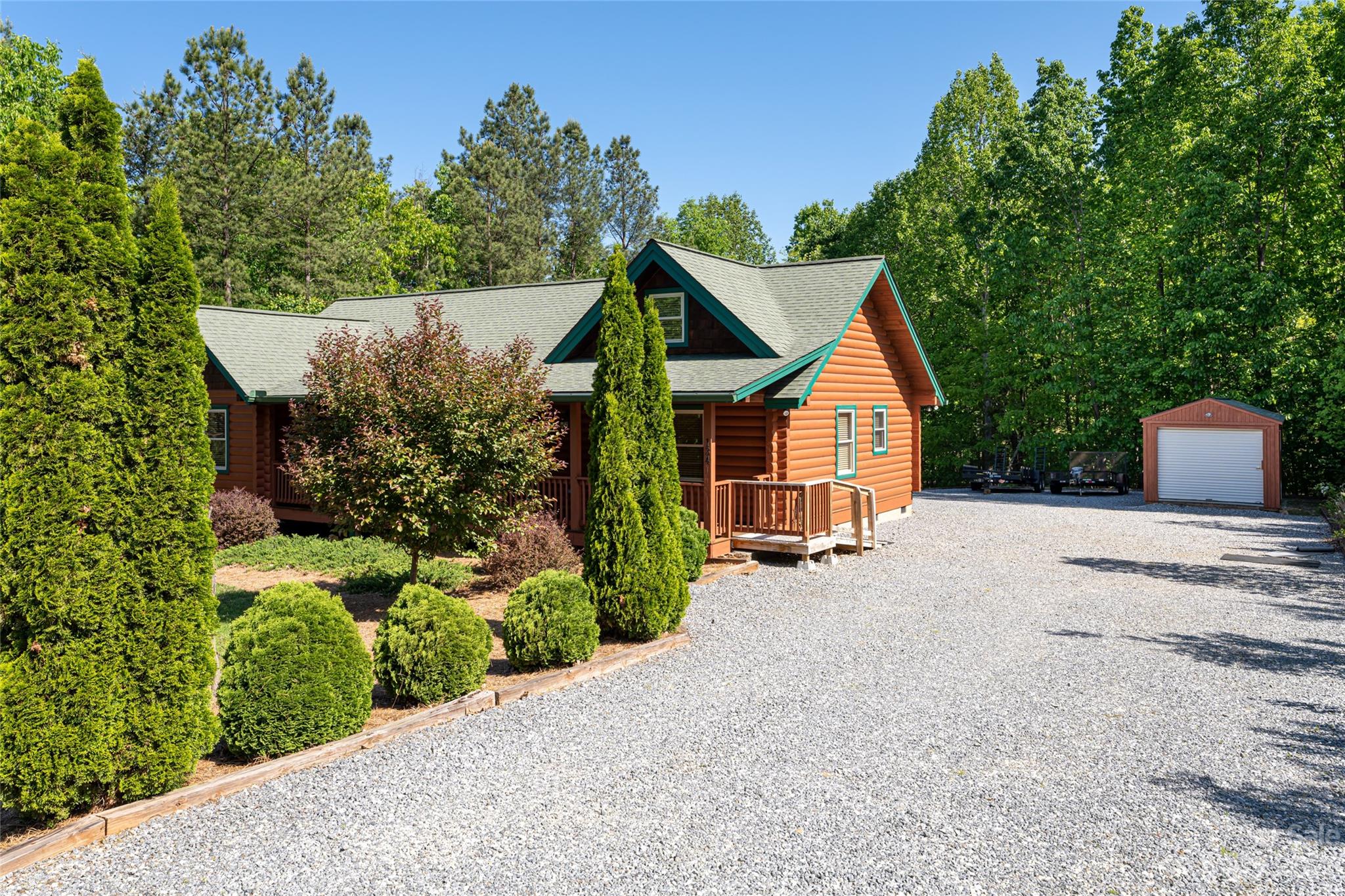 134 Quebec Trail Bostic, NC 28018 - Photo 27 of 37 a front view of a house with a yard and trees