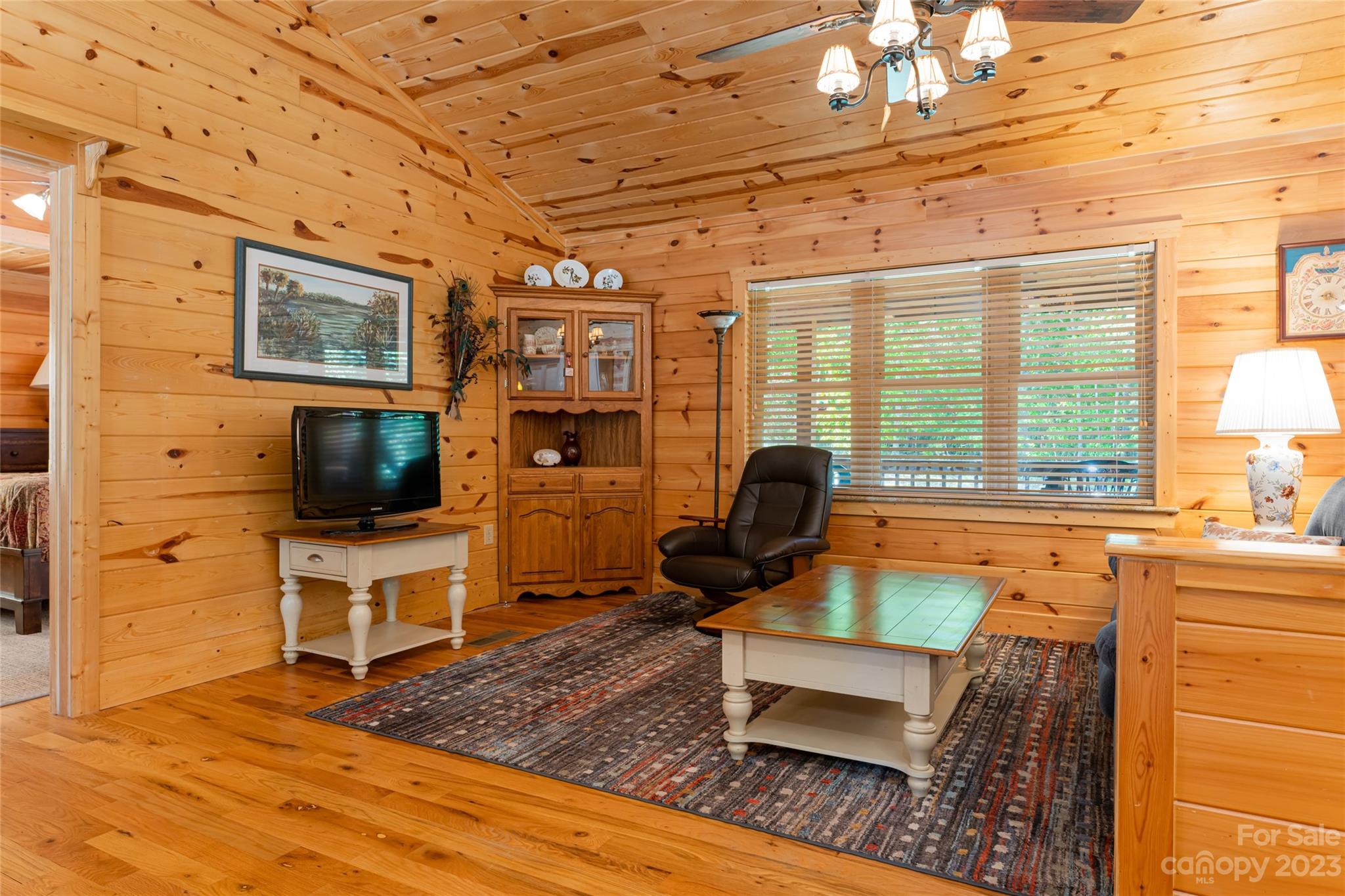 134 Quebec Trail Bostic, NC 28018 - Photo 8 of 37 a living room with furniture a flat screen tv and a floor to ceiling window