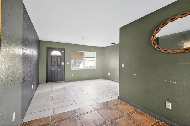 an empty room with closet and mirror