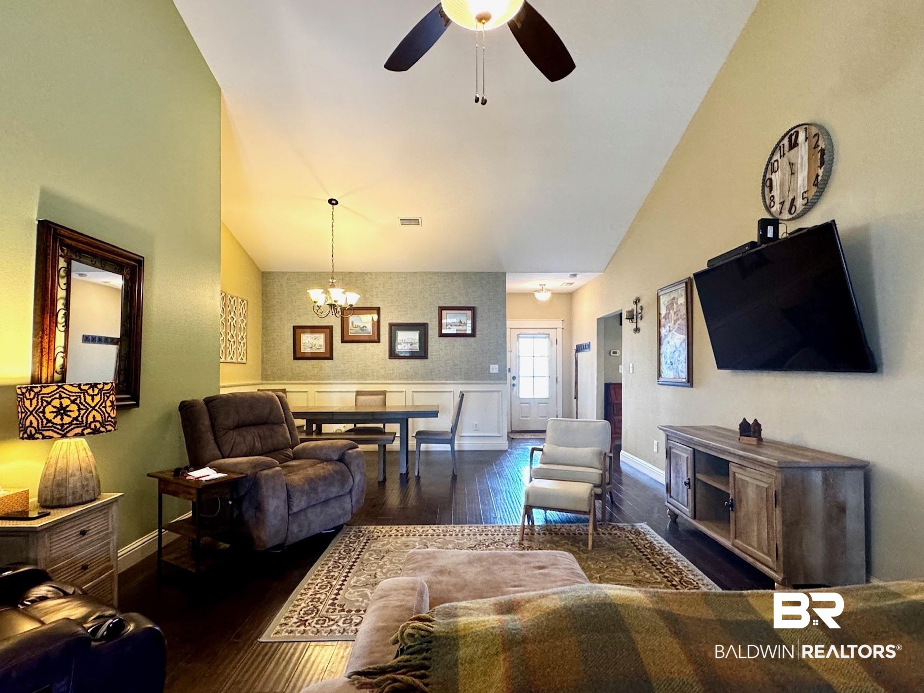 1030 Crown Walk Drive Foley, AL 36535 - Photo 3 of 40 Living area with hardwood / wood-style floors, visible vents, baseboards, high vaulted ceiling, and ceiling fan with notable chandelier