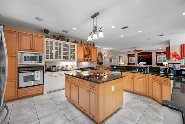 a kitchen with stainless steel appliances granite countertop a stove and a sink