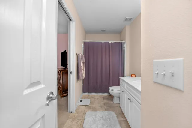 a white bath tub sitting next to a white toilet