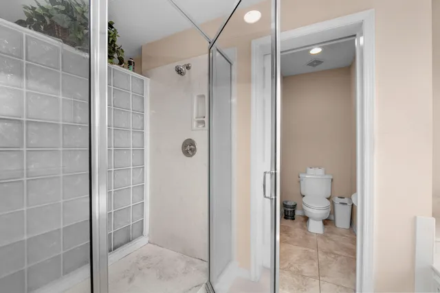 a bedroom with a bed and dresser with mirror