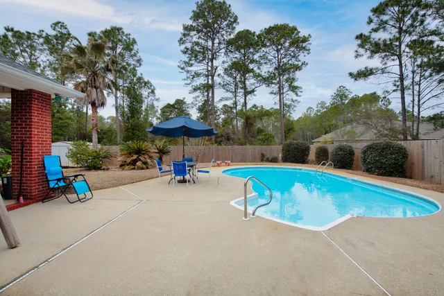 an outdoor space with pool and furniture