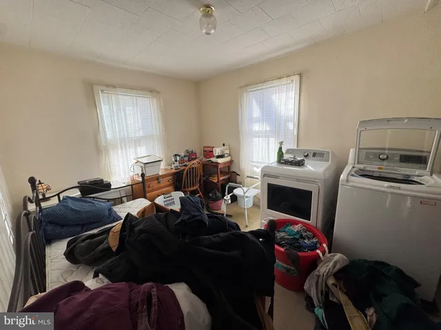 a room with furniture a flat screen tv and a window