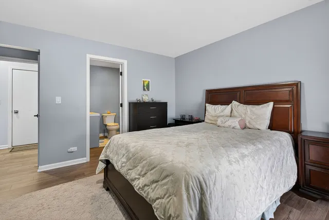 a bedroom with a bed and wooden floor