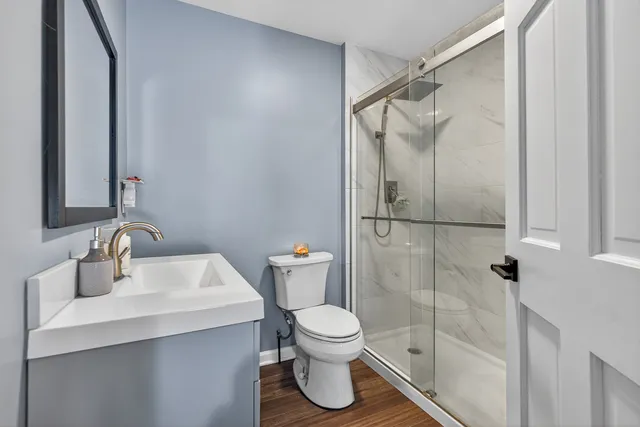 a bathroom with a toilet sink and shower