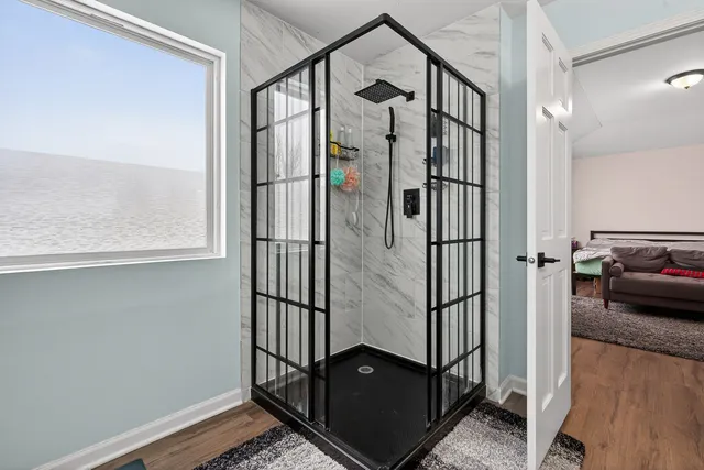 a view of staircase with wooden floor and a window