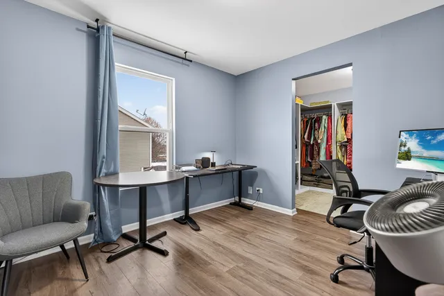 a view of a workspace with furniture and a window