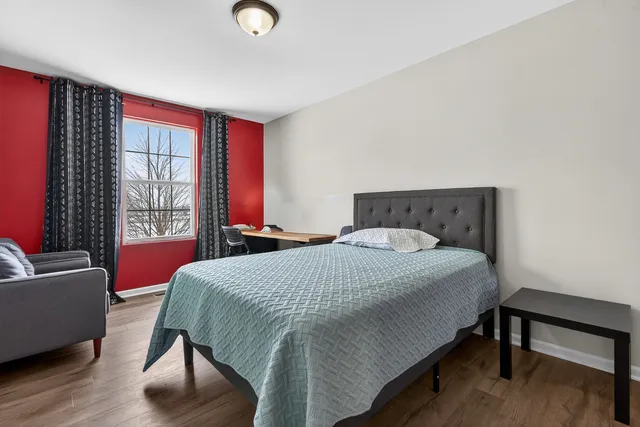 a bedroom with a bed and a window