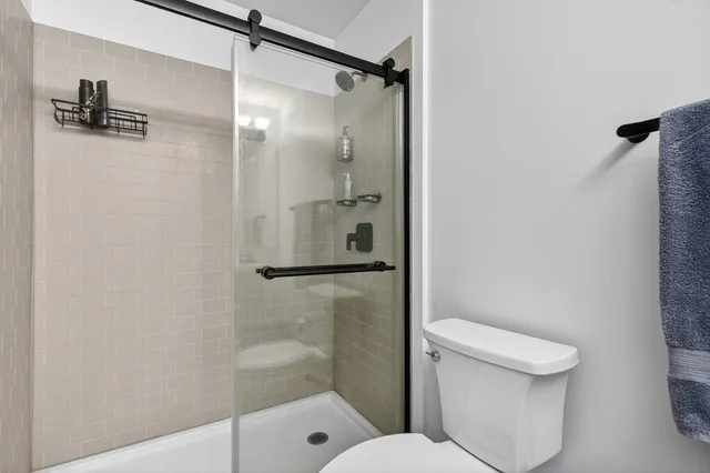 a bathroom with a toilet and a shower